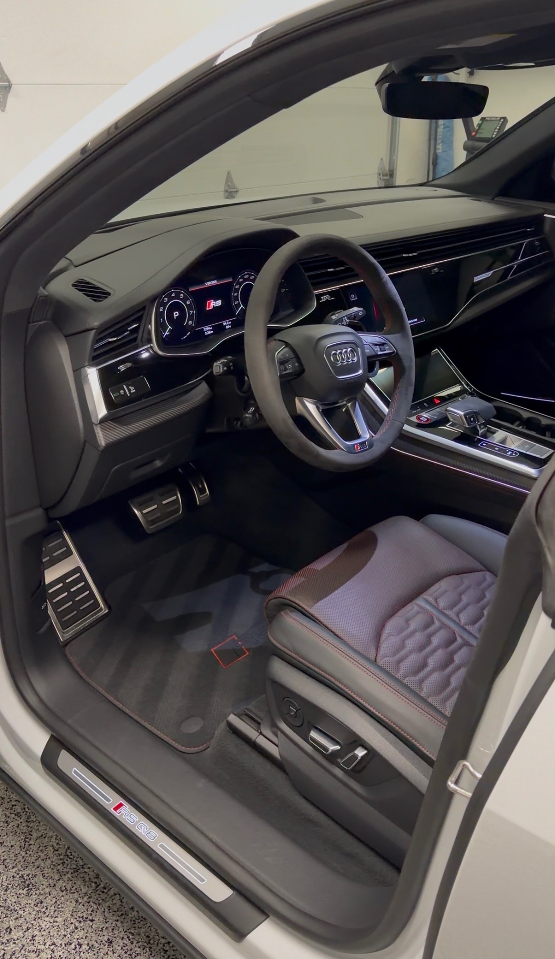 Spotless detailed Audi RS Q8 interior with clean carbon trim and floor mats